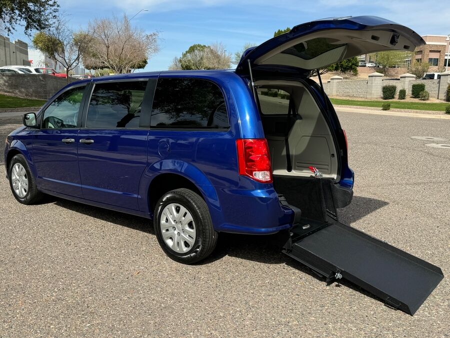 Blue Dodge Grand Caravan with International Sales and Mobility Rear Entry Manual Fold Out conversion